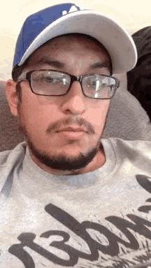 a man wearing glasses and a hat is wearing a shirt that says rebound