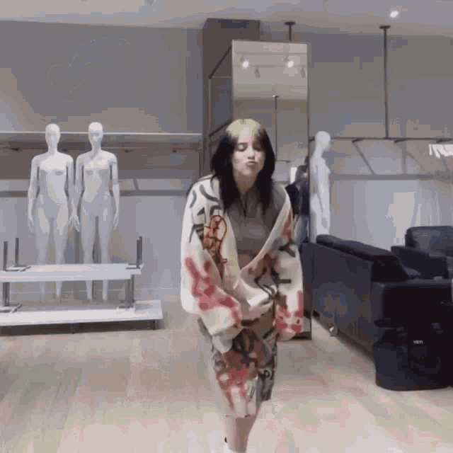 a woman with green hair is dancing in a store