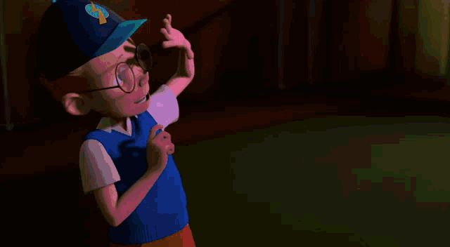 a boy wearing glasses and a hat with the letter s on it is holding a blue plate