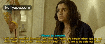 a woman in a black shirt is talking to a man in a room with a caption that says " please be sensible "