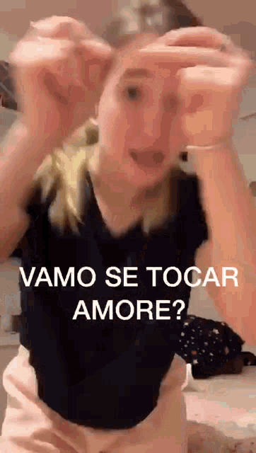 a woman is making a funny face with the words " vamo se tocar amore " on the bottom