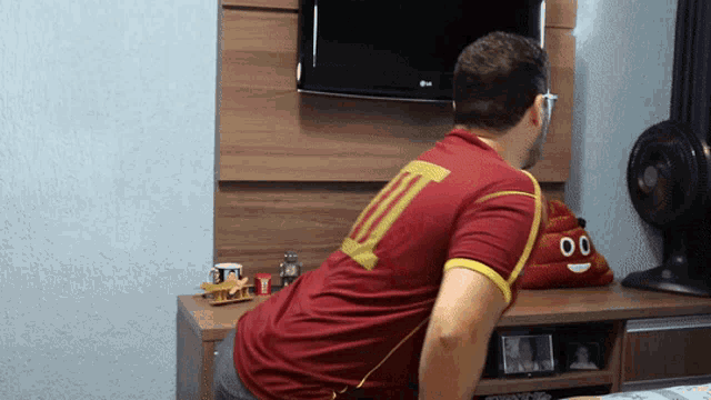a man in a red shirt has the number 10 on his back