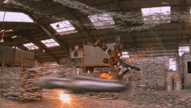 a person is flying through the air in a warehouse surrounded by chains