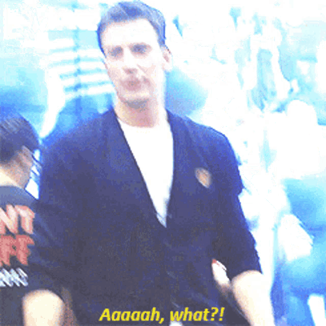 a man in a black jacket says aaaah what on the screen