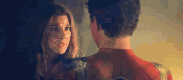 a man and a woman are looking at each other in a room .