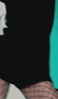 a close up of a person 's face with a black background and a blue object in the background .