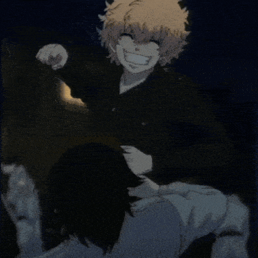 a man and a woman are standing next to each other in the dark .