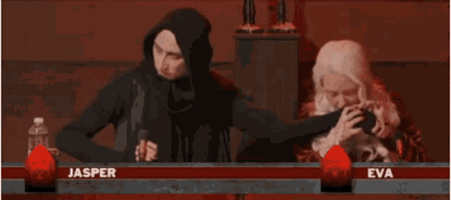 jasper and eva are sitting at a table with red candles