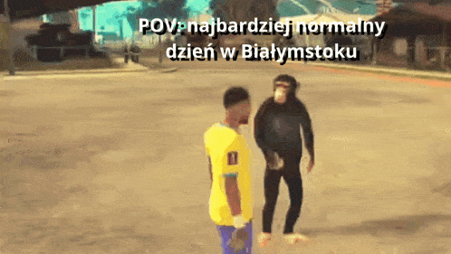a man in a yellow shirt is talking to a chimpanzee