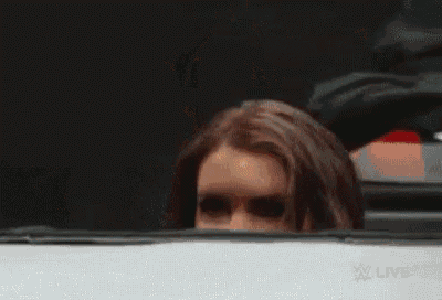 a close up of a woman 's face behind a car window .