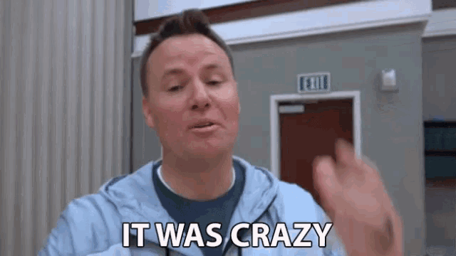 a man says it was crazy in front of a red exit sign