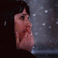 a woman with a bloody nose is blowing a kiss in the rain .