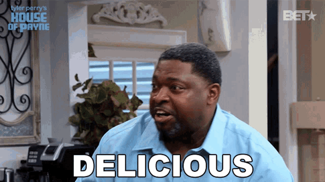 a man in a blue shirt says " delicious "