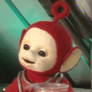 a red teletubbies doll is holding a cup of water .
