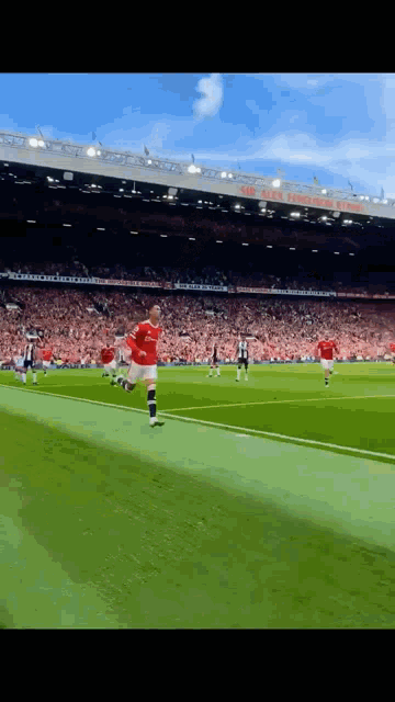 a soccer player in a red jersey is kicking a ball