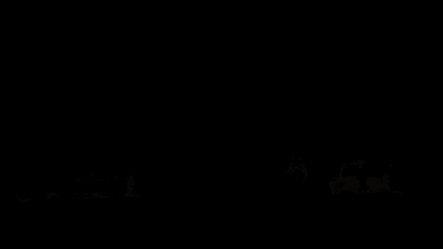 a white van is parked in a foggy parking lot at night