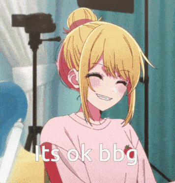 a girl with blonde hair is smiling with the words it 's ok bbg below her