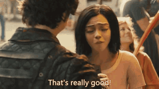 a man and a woman are standing next to each other and the woman says that 's really good