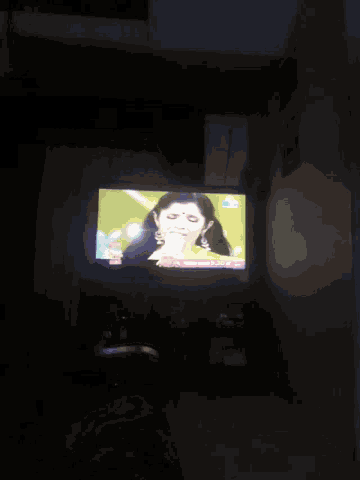 a tv with a picture of a woman on it and the word disney on the bottom right
