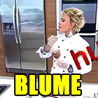 a woman in a chef 's uniform is standing in front of a refrigerator with the word blume written on it