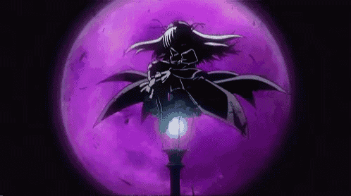 a person is standing next to a lamp post in front of a purple light .