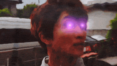 a close up of a person 's face with purple lights coming out of their eyes