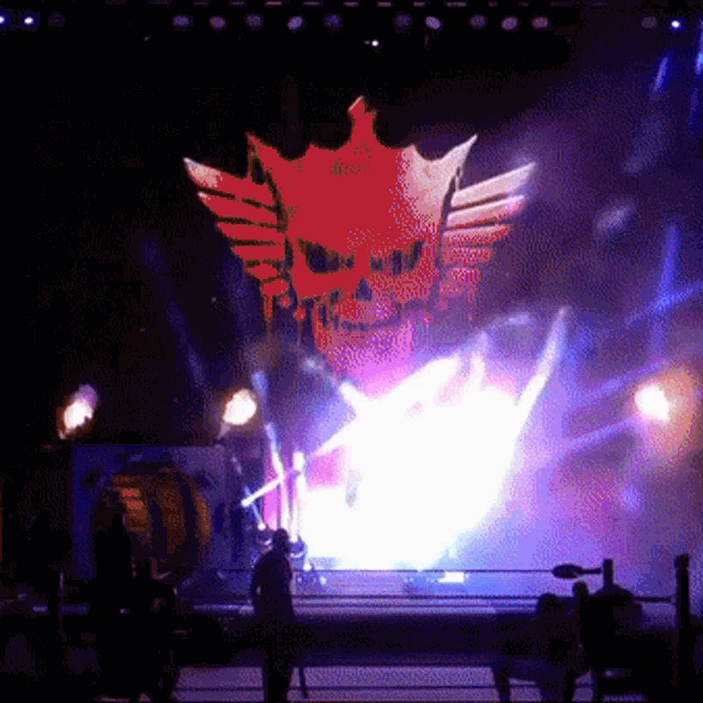 a skull with wings and a crown is on a stage