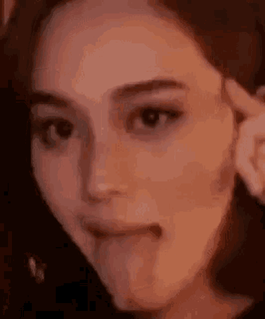 a close up of a woman 's face with her tongue sticking out .