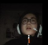 a person wearing glasses and headphones with a microphone on their head
