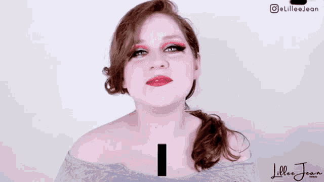a woman is making a face and saying `` appreciate '' with her hands .