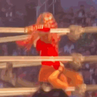 a woman is standing in a boxing ring wearing a santa hat .