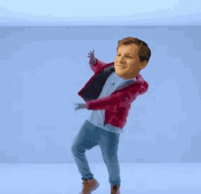 a man wearing a pink jacket and a white shirt is dancing in front of a blue wall .