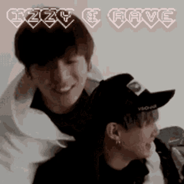 a couple of men are standing next to each other and one of them is wearing a hat with the word rave written on it .