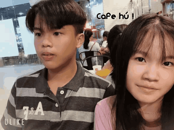 a boy and a girl are posing for a picture and the girl is wearing a shirt that says a & a