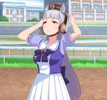 a girl in a purple and white dress adjusts her ear muffs