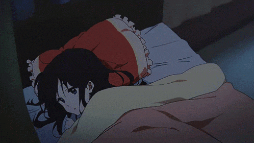 a girl in a red dress is laying in a bed