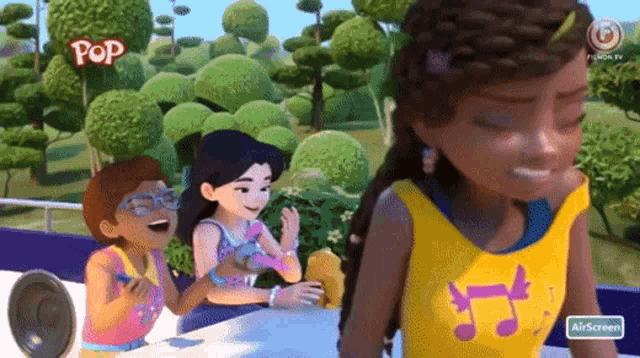 a girl in a yellow top with music notes on it is standing next to two other girls in a cartoon .