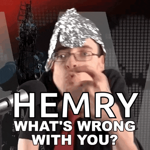 a man wearing a tin foil hat and glasses is asking the question " hemry what 's wrong with you "