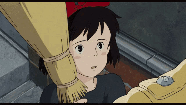 a girl with a red bow on her head is holding a broom in her hand