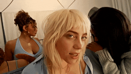 a woman with blonde hair is looking at the camera