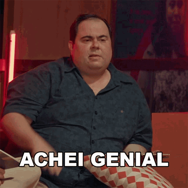 a man is sitting in a chair with achei genial written on the bottom