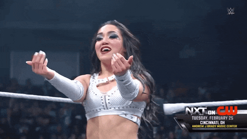 a woman is in a wrestling ring with the words nxt on display