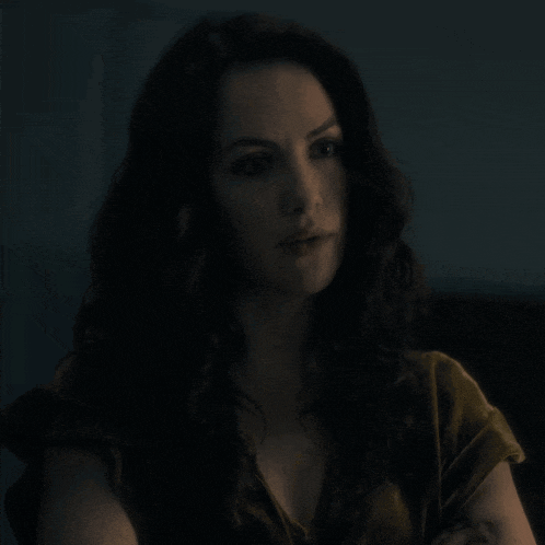 a close up of a woman 's face in the dark
