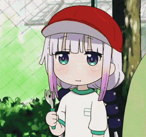 a girl with a red hat is holding a fork in her hand .