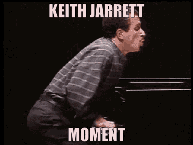 a man is playing a piano with the words keith jarrett moment below him