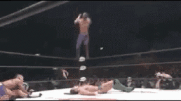 a man is laying on his back in a boxing ring .