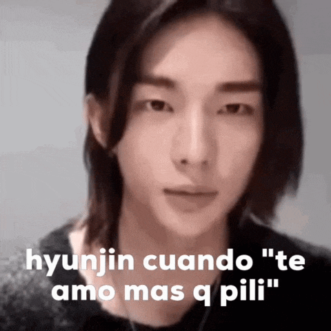 a close up of a person 's face with the words " hyunjin cuando te amo mas q pili " written on it