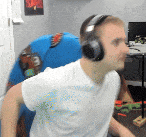 a man wearing headphones in a room with a picture on the wall behind him