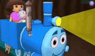 a blue train with a face on it is being pulled by a monkey and a girl .