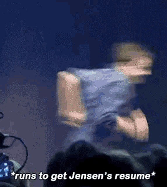 a person is dancing on a stage with the words " runs to get jensen 's resume " written below them .